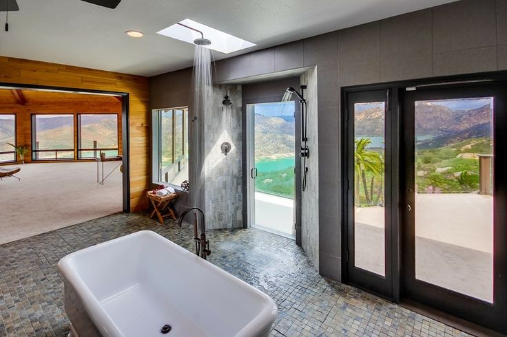 Example of a large trendy master beige tile, gray tile and stone tile ceramic tile and beige floor bathroom design in San Diego with open cabinets, light wood cabinets, a two-piece toilet, gray walls, a vessel sink, wood countertops and a hinged shower door