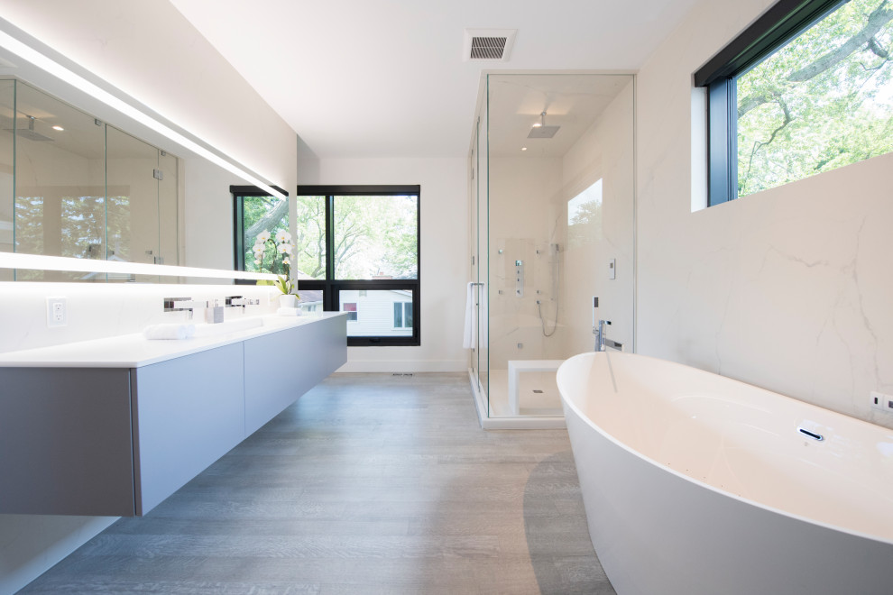 Large trendy master gray tile, white tile and porcelain tile gray floor and double-sink bathroom photo in Toronto with flat-panel cabinets, gray cabinets, white walls, an undermount sink, a hinged shower door, white countertops and a floating vanity