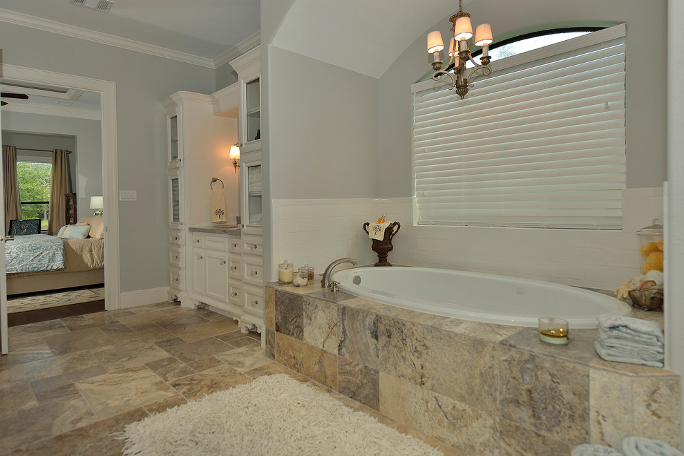 Идея дизайна: большая ванная комната в классическом стиле с фасадами с утопленной филенкой, белыми фасадами, накладной ванной, разноцветной плиткой, каменной плиткой, белыми стенами, полом из известняка, душевой кабиной, врезной раковиной и столешницей из гранита