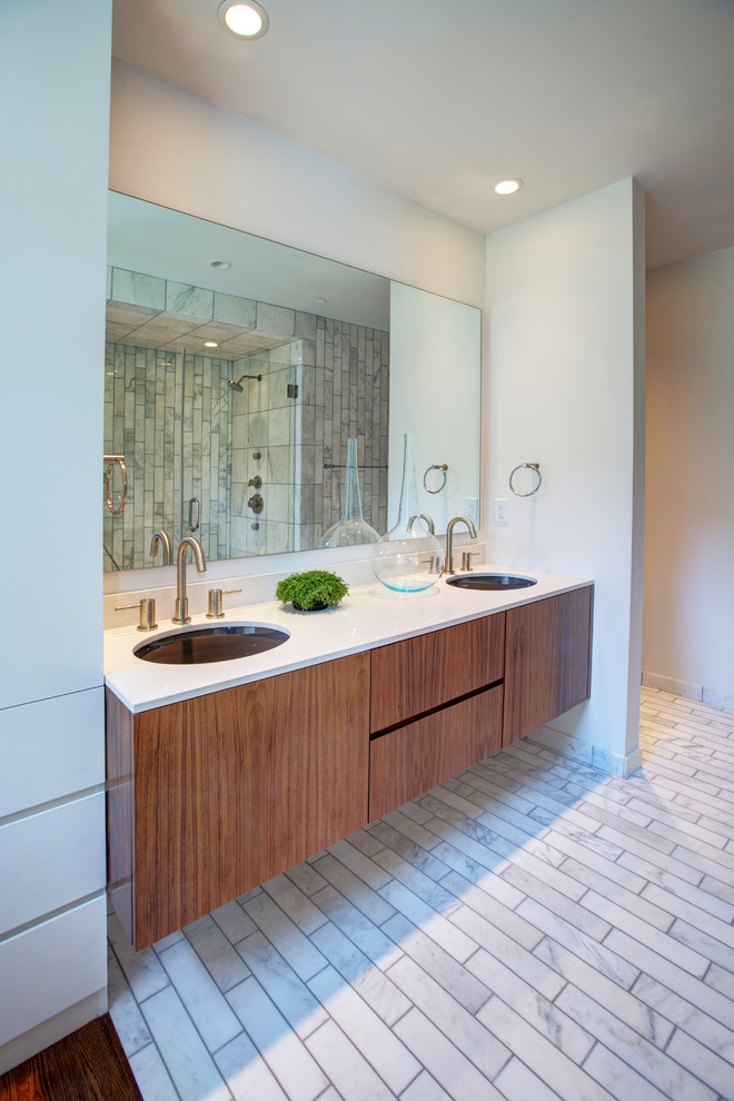 Inspiration for a mid-sized contemporary master white tile and stone tile marble floor double shower remodel in Oklahoma City with an undermount sink, flat-panel cabinets, medium tone wood cabinets, quartz countertops, a wall-mount toilet and white walls