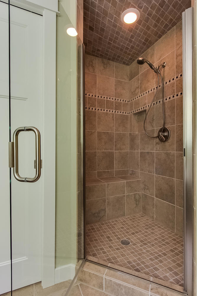 Example of a mid-sized country master beige tile and ceramic tile ceramic tile bathroom design in Minneapolis with an integrated sink, shaker cabinets, medium tone wood cabinets, solid surface countertops, a one-piece toilet and green walls