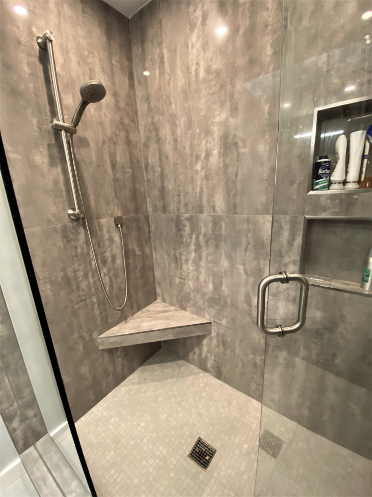 Mid-sized trendy master gray tile and porcelain tile porcelain tile, gray floor and double-sink bathroom photo in DC Metro with flat-panel cabinets, gray cabinets, a two-piece toilet, gray walls, an undermount sink, quartz countertops, a hinged shower door, gray countertops and a floating vanity