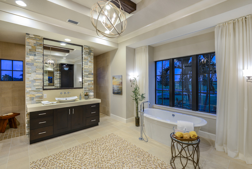 Bathroom - huge contemporary master beige tile and mosaic tile porcelain tile bathroom idea in Tampa with flat-panel cabinets, dark wood cabinets, a two-piece toilet, beige walls, a vessel sink and solid surface countertops
