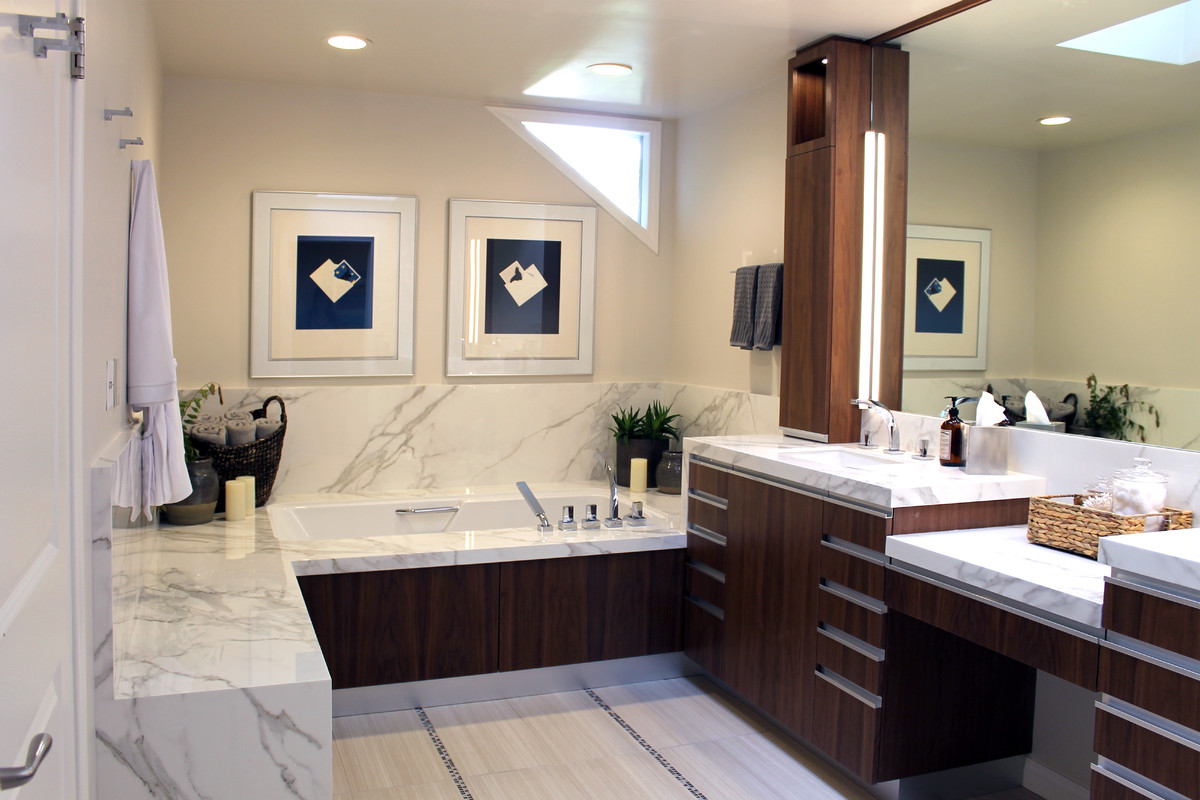 Example of a large minimalist master beige tile and porcelain tile porcelain tile and beige floor alcove shower design in Los Angeles with flat-panel cabinets, dark wood cabinets, an undermount tub, a one-piece toilet, beige walls, an undermount sink, quartz countertops and a hinged shower door