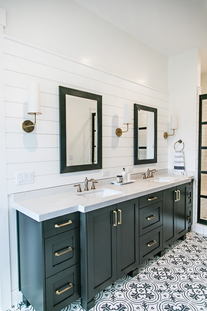 This is an example of a large rural ensuite bathroom in Salt Lake City with shaker cabinets, black cabinets, an alcove shower, white tiles, metro tiles, multi-coloured walls, cement flooring, a submerged sink, engineered stone worktops, white floors, a hinged door and white worktops.