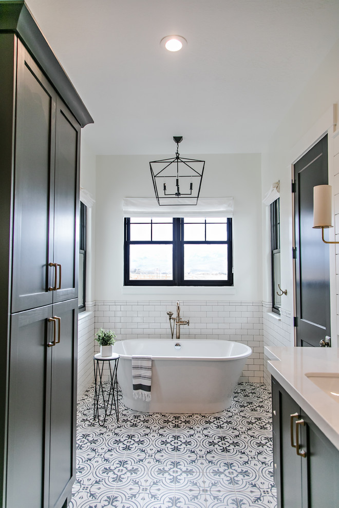 Inspiration for a large cottage master white tile and subway tile cement tile floor and white floor bathroom remodel in Salt Lake City with shaker cabinets, black cabinets, multicolored walls, an undermount sink, quartz countertops, a hinged shower door and white countertops