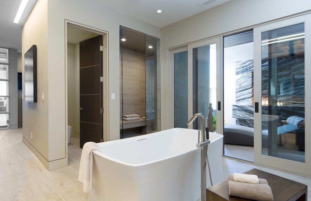 Design ideas for an expansive contemporary ensuite wet room bathroom in Sacramento with a freestanding bath, a one-piece toilet, blue tiles, brown tiles, grey tiles, porcelain tiles, beige walls, porcelain flooring, flat-panel cabinets, dark wood cabinets, a vessel sink and engineered stone worktops.