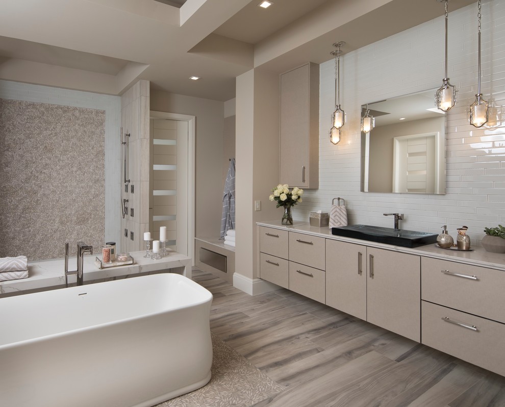 Inspiration for a large contemporary master white tile and porcelain tile medium tone wood floor and multicolored floor bathroom remodel in Orlando with flat-panel cabinets, beige cabinets, a one-piece toilet, beige walls, a console sink and quartz countertops