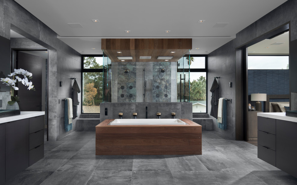 Inspiration for a large contemporary master gray tile and porcelain tile porcelain tile and gray floor bathroom remodel in Las Vegas with flat-panel cabinets, dark wood cabinets, a bidet, gray walls, a vessel sink, quartz countertops, a hinged shower door and white countertops
