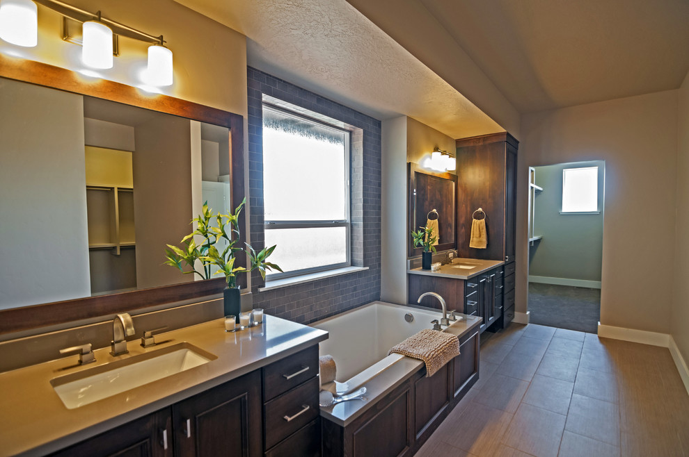 Bathroom - large craftsman master brown tile and ceramic tile ceramic tile bathroom idea in Boise with an undermount sink, beaded inset cabinets, dark wood cabinets, quartzite countertops, a one-piece toilet and gray walls