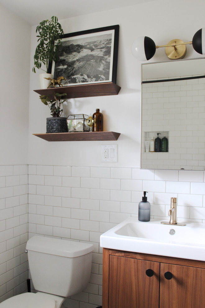 Inspiration for a contemporary white tile and subway tile bathroom remodel in Portland with flat-panel cabinets, medium tone wood cabinets, white walls and a console sink