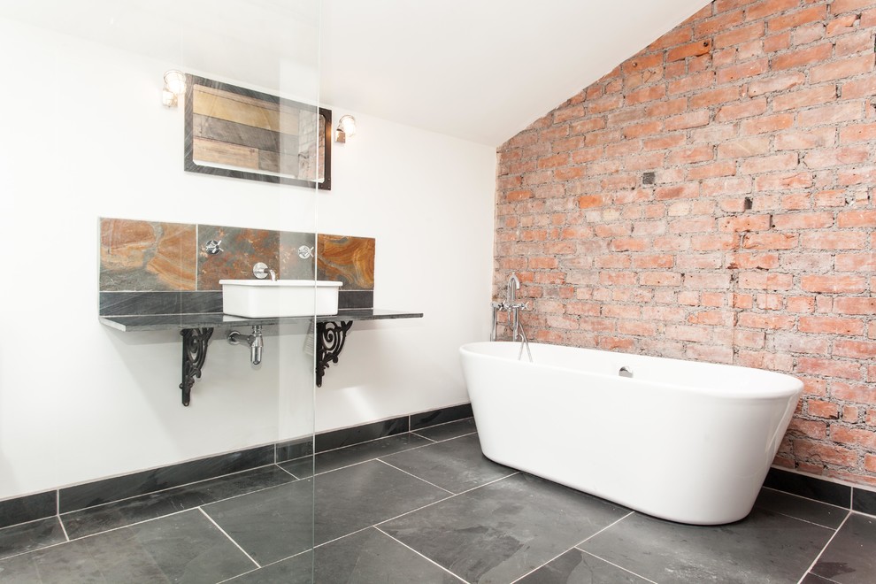 Inspiration for a medium sized urban bathroom in Other with a freestanding bath, a one-piece toilet, black tiles, white walls, slate flooring, a vessel sink, an open shower and slate tiles.