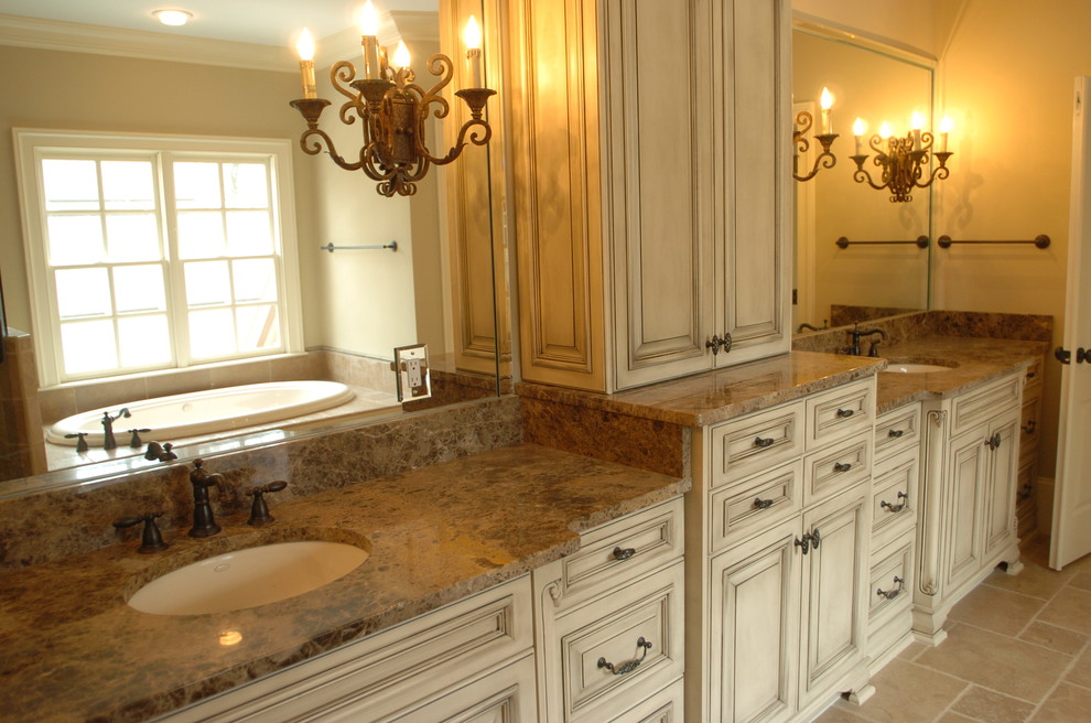 This is an example of a large classic ensuite bathroom in Atlanta with shaker cabinets, beige cabinets, stone tiles, beige walls, marble worktops, a built-in bath, a corner shower, travertine flooring and a submerged sink.