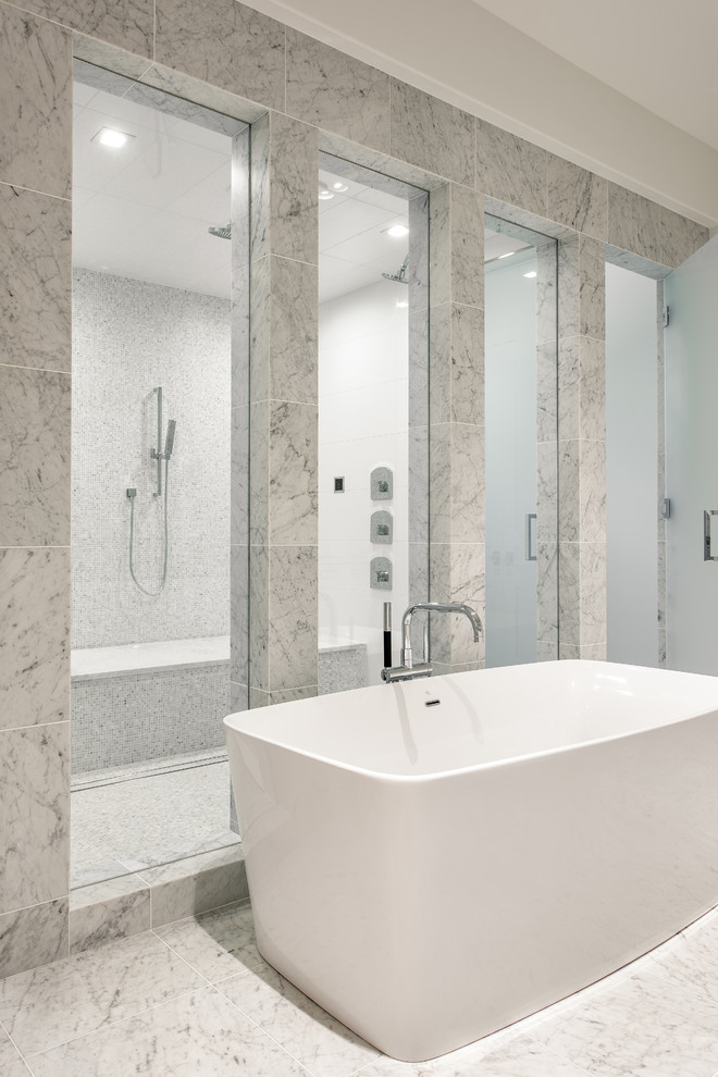 Classic ensuite bathroom in Charlotte with flat-panel cabinets, white cabinets, a freestanding bath, a double shower, a wall mounted toilet, white tiles, marble tiles, white walls, marble flooring, a submerged sink, marble worktops, white floors and a hinged door.