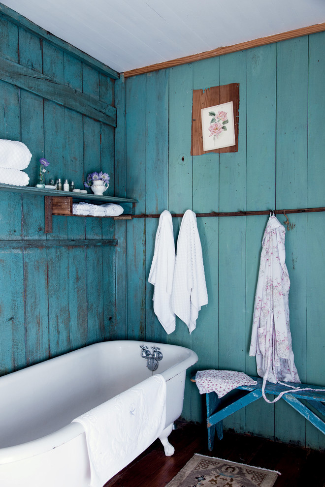 На фото: ванная комната в стиле шебби-шик с ванной на ножках и синими стенами