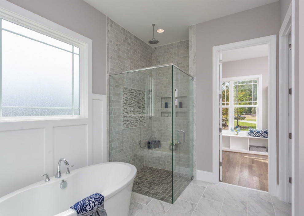 Design ideas for a large traditional ensuite bathroom in Raleigh with a freestanding bath, a corner shower, grey tiles, marble tiles, grey walls, marble flooring, grey floors and a hinged door.