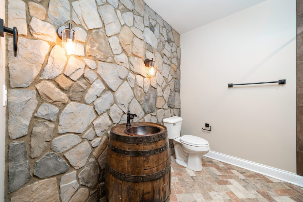 Photo of a rustic bathroom in Louisville with brown cabinets, a shower/bath combination, stone slabs, brick flooring, a built-in sink, wooden worktops, orange floors, a shower curtain, a single sink and a freestanding vanity unit.