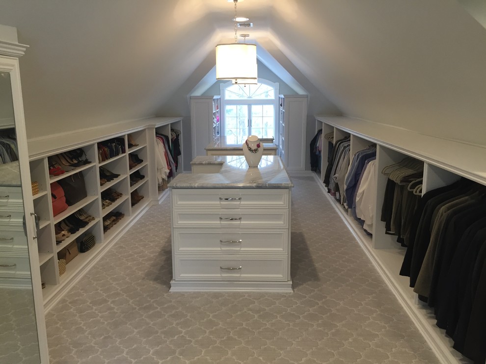 This is an example of a large traditional wardrobe in New York with recessed-panel cabinets, grey cabinets and marble flooring.