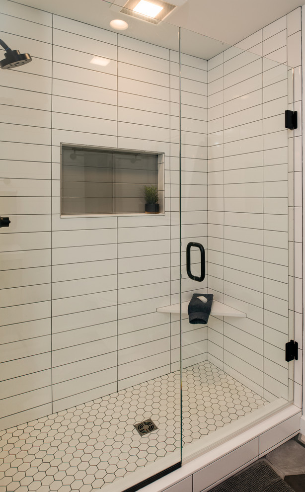 Photo of a small traditional shower room bathroom in Other with flat-panel cabinets, brown cabinets, an alcove shower, a one-piece toilet, white tiles, white walls, porcelain flooring, a trough sink, concrete worktops, multi-coloured floors, a hinged door and white worktops.