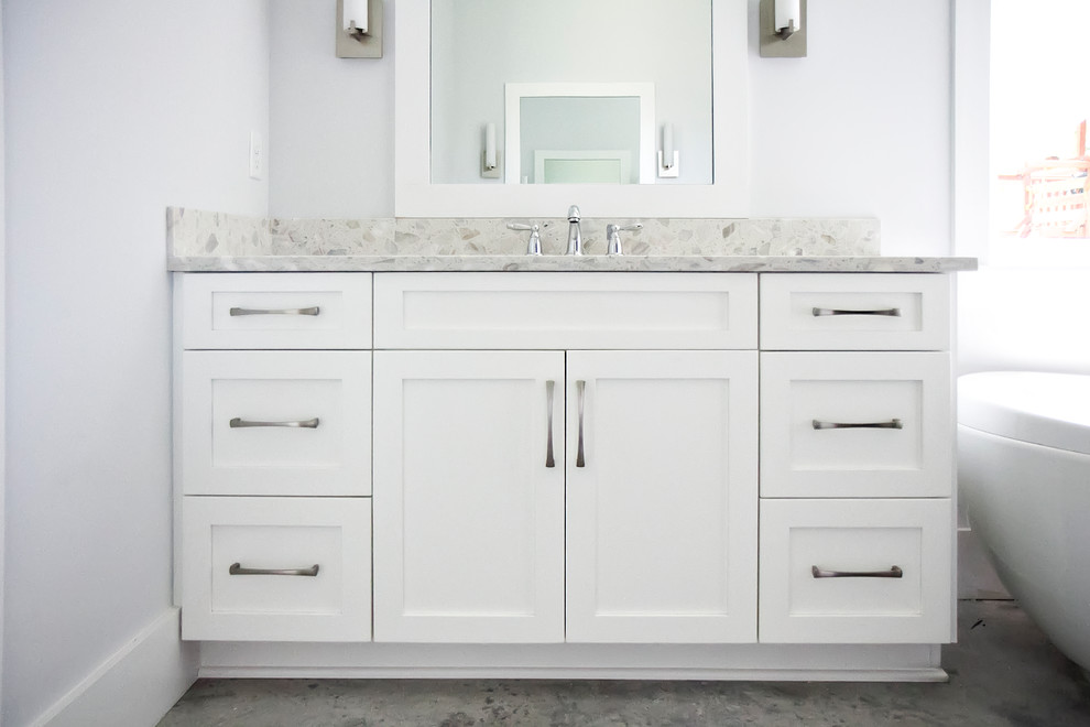 Inspiration for a medium sized modern ensuite bathroom in Jacksonville with shaker cabinets, white cabinets, a freestanding bath, concrete worktops, white walls, concrete flooring and a submerged sink.