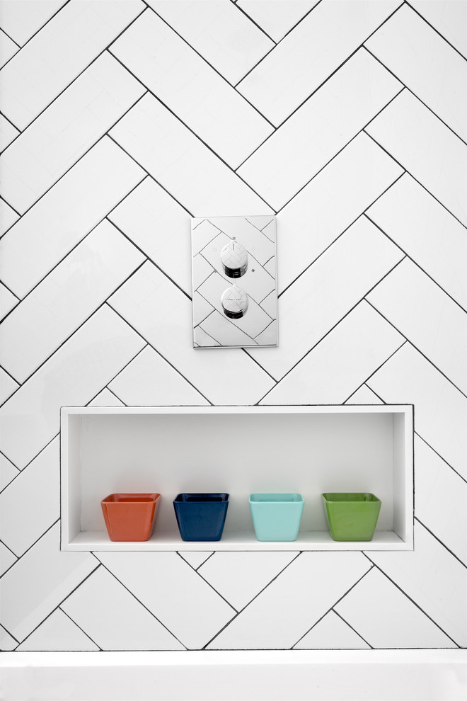 Inspiration for a mid-sized modern kids' white tile and subway tile cement tile floor and black floor bathroom remodel in New York with flat-panel cabinets, white cabinets, a wall-mount toilet, white walls, a wall-mount sink and marble countertops