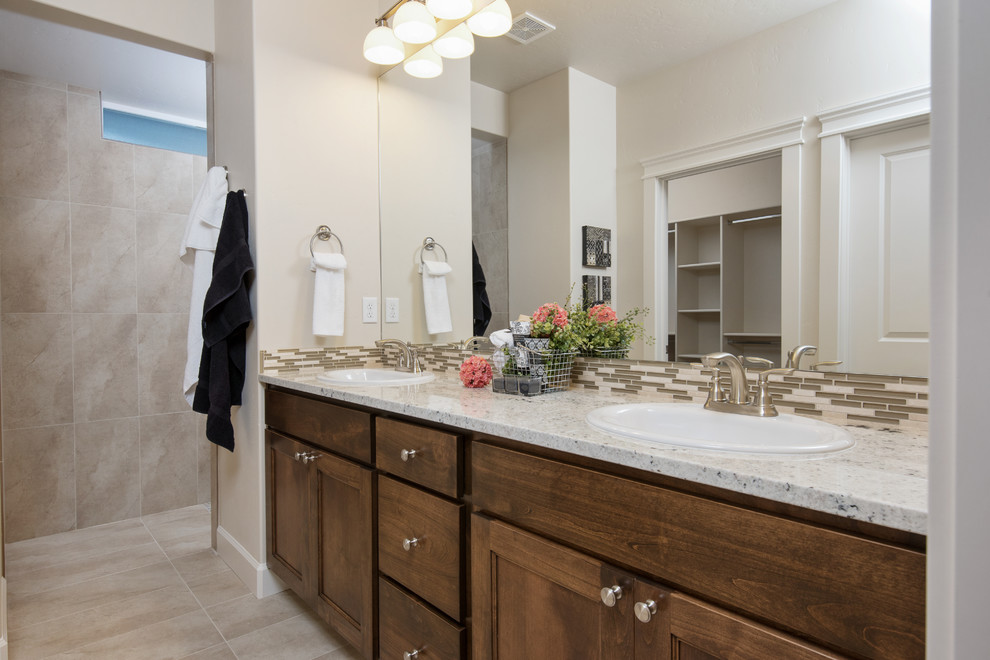 Photo of a medium sized classic ensuite bathroom in Boise with raised-panel cabinets, medium wood cabinets, a built-in shower, a two-piece toilet, beige tiles, mosaic tiles, beige walls, porcelain flooring, a built-in sink and granite worktops.