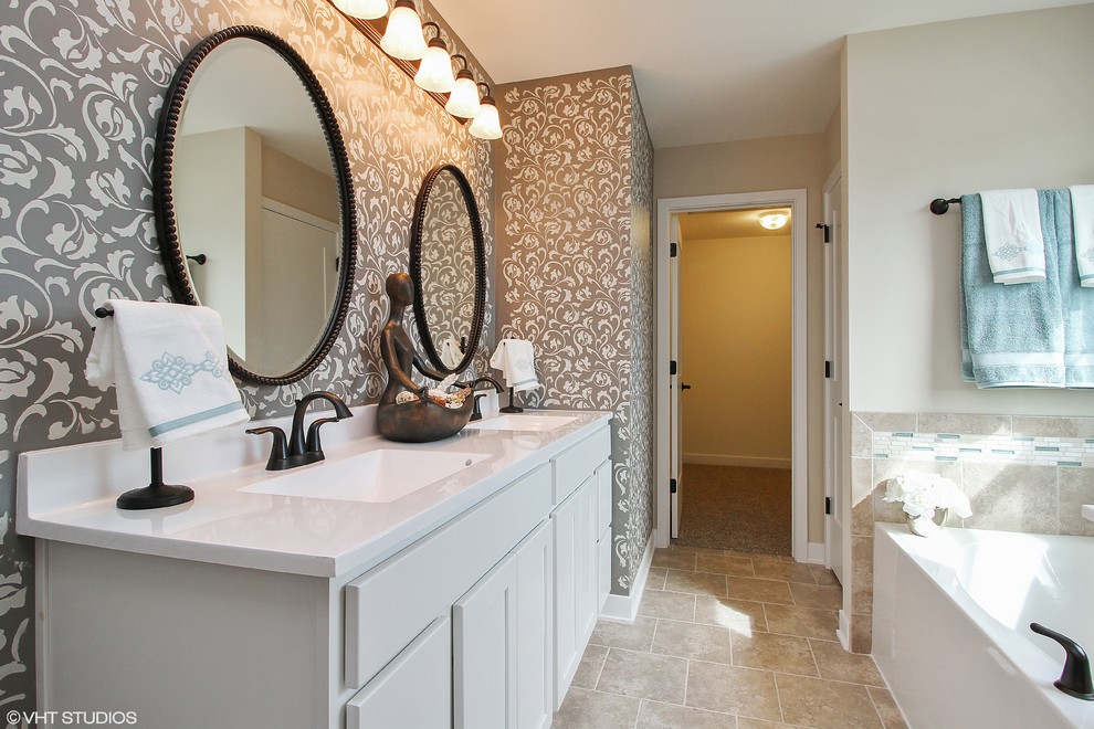 Inspiration for a traditional ensuite bathroom in Chicago with recessed-panel cabinets, white cabinets, a corner bath, a corner shower, a one-piece toilet, beige tiles, ceramic tiles, beige walls, ceramic flooring, a wall-mounted sink, engineered stone worktops, beige floors and a hinged door.