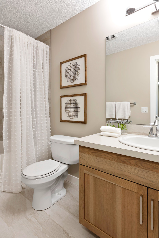 Classic bathroom in Calgary with shaker cabinets, medium wood cabinets, a freestanding bath, beige walls, a built-in sink, beige floors and white worktops.