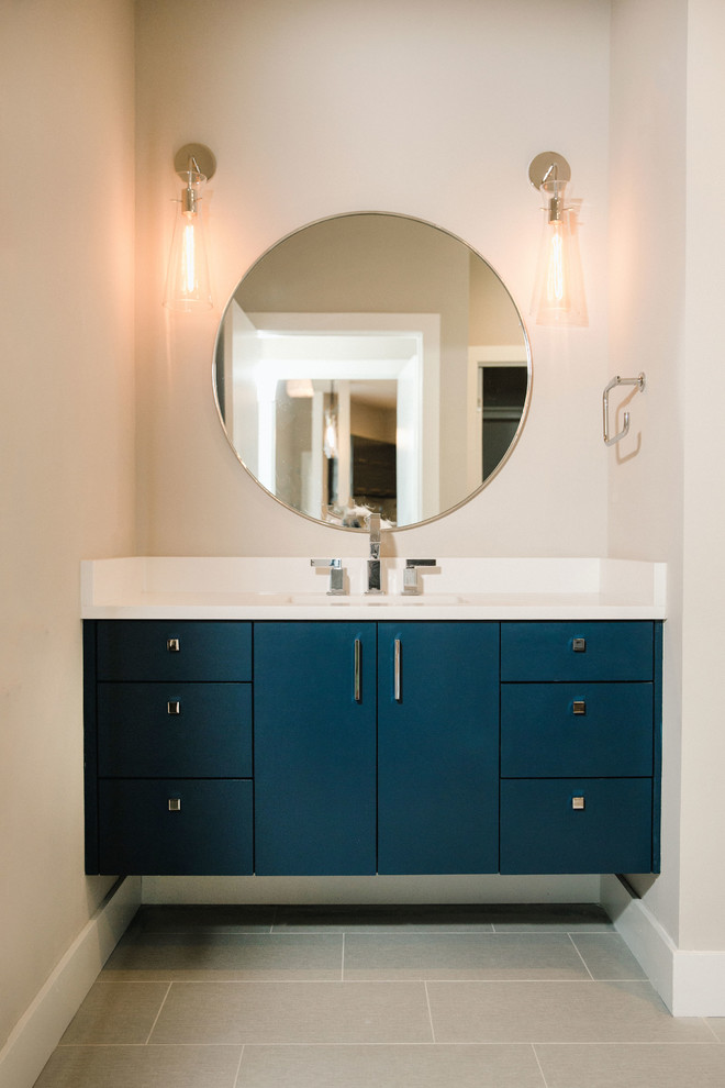 Свежая идея для дизайна: ванная комната среднего размера в классическом стиле с плоскими фасадами, угловой ванной, угловым душем, белой плиткой, белыми стенами, столешницей из искусственного кварца, серым полом, душем с распашными дверями, белой столешницей, синими фасадами, полом из керамогранита и врезной раковиной - отличное фото интерьера