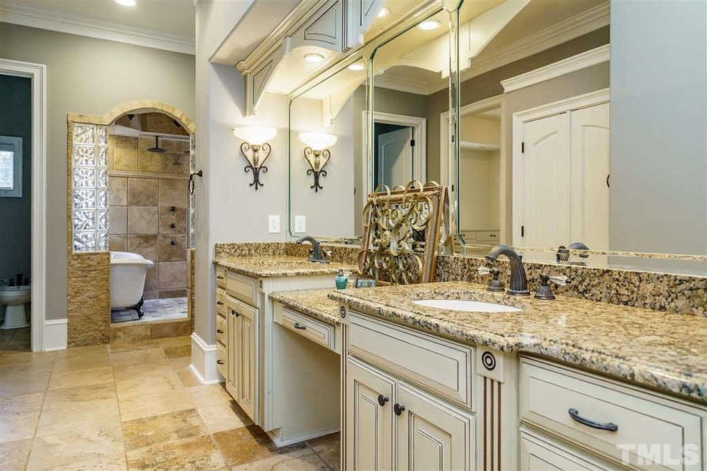 Large elegant master beige floor bathroom photo in Raleigh with raised-panel cabinets, beige cabinets, beige walls, an undermount sink, granite countertops and multicolored countertops