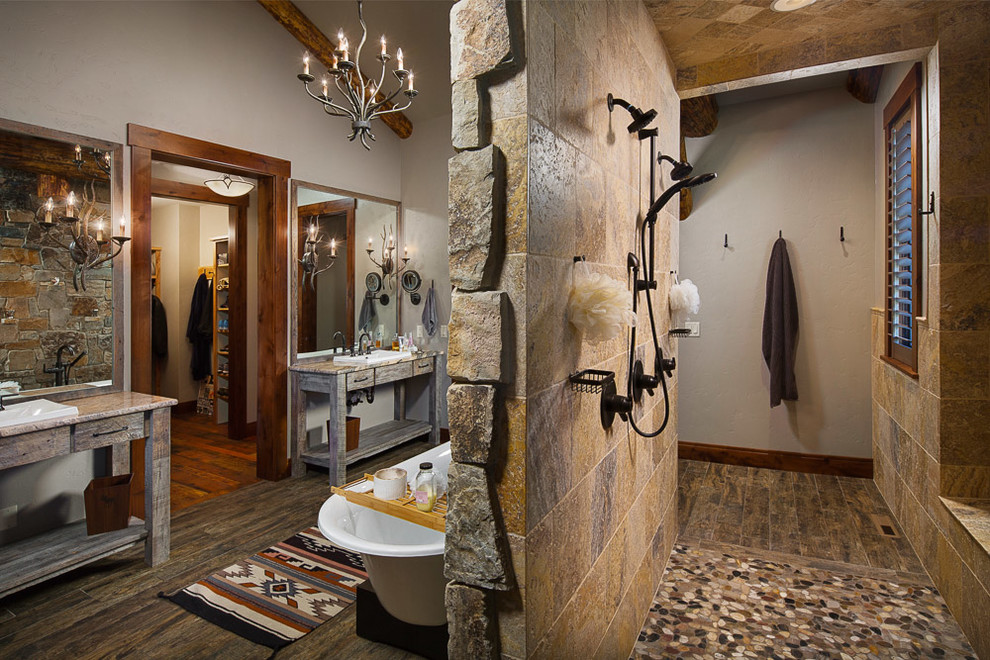 Inspiration for a large rustic master dark wood floor bathroom remodel in Other with flat-panel cabinets, distressed cabinets, a two-piece toilet, gray walls, a vessel sink and granite countertops