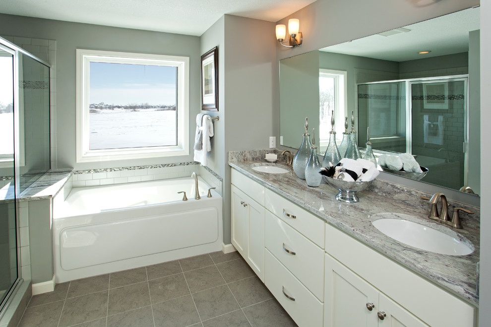 Inspiration for a drop-in bathtub remodel in Minneapolis with white cabinets, quartzite countertops and gray walls