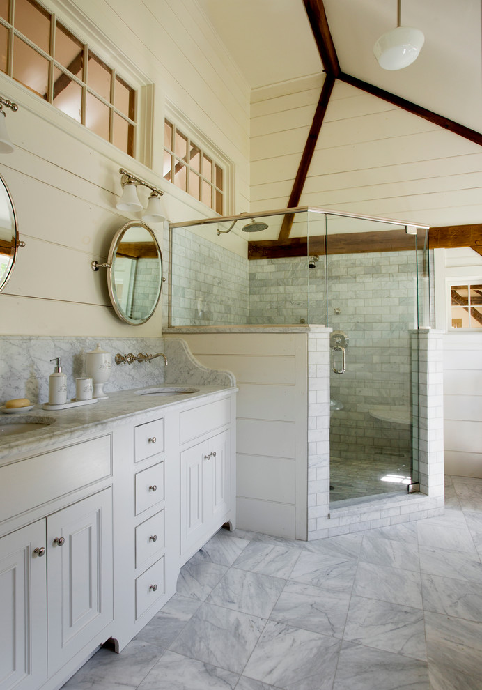 Photo of a medium sized farmhouse ensuite bathroom in Boston with white cabinets, marble worktops, a corner shower, white tiles, ceramic tiles, white walls, marble flooring, a submerged sink, beaded cabinets and a two-piece toilet.