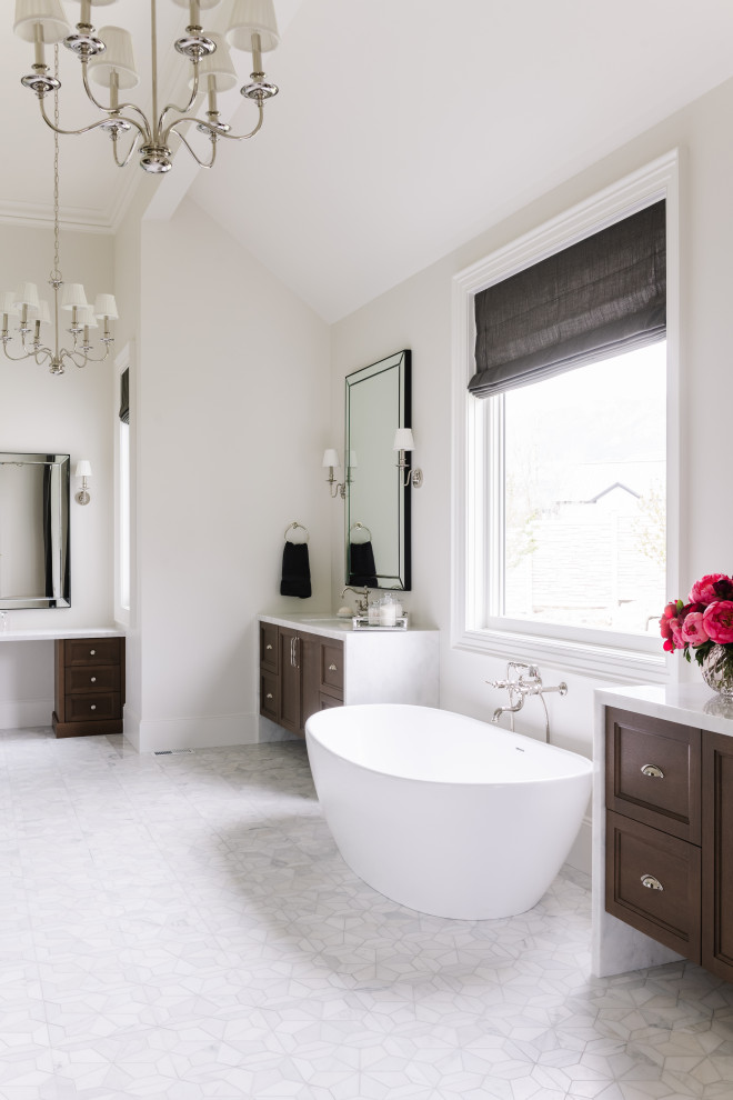 This is an example of a large classic ensuite bathroom in Salt Lake City with shaker cabinets, a freestanding bath, white walls, marble flooring, a built-in sink, white floors, white worktops, double sinks and a built in vanity unit.