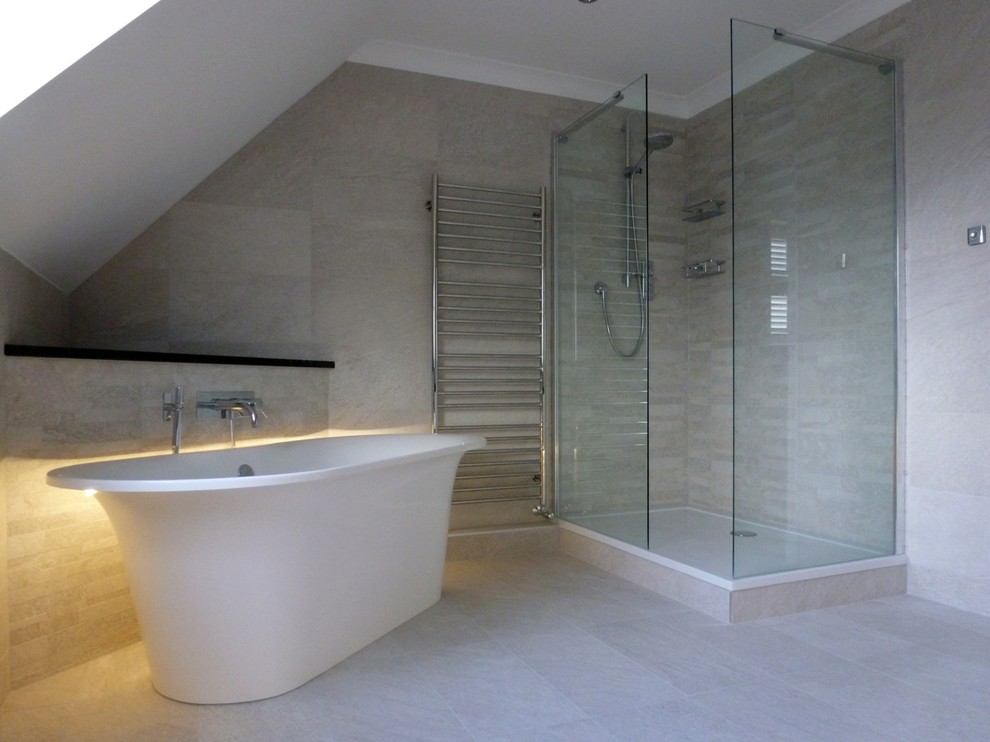 This is an example of a large contemporary ensuite bathroom in Berkshire with a freestanding bath, a walk-in shower, a one-piece toilet, grey tiles, porcelain tiles, grey walls and porcelain flooring.