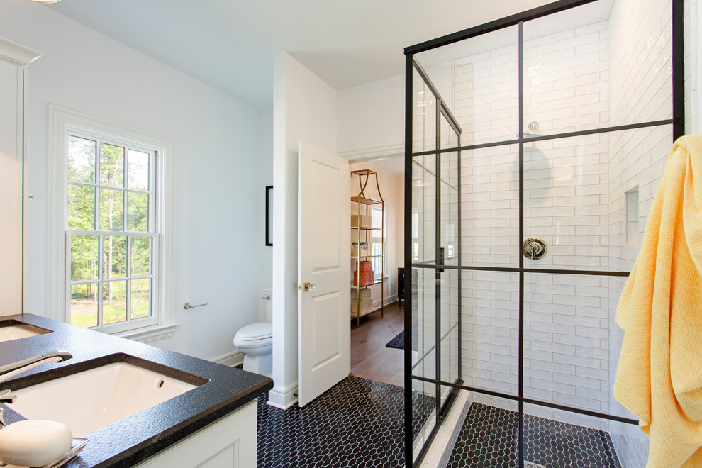 Medium sized classic shower room bathroom in Richmond with recessed-panel cabinets, white cabinets, a corner shower, a one-piece toilet, black and white tiles, white walls and a submerged sink.