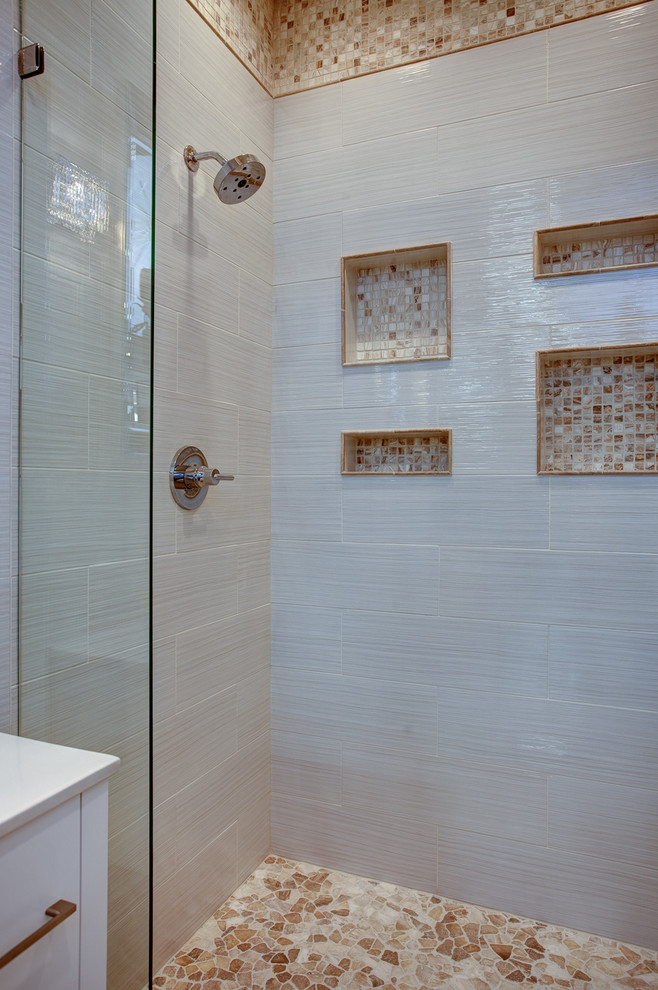 Photo of a coastal bathroom in Little Rock with flat-panel cabinets, white cabinets, a walk-in shower, beige tiles, ceramic tiles, beige walls and travertine flooring.