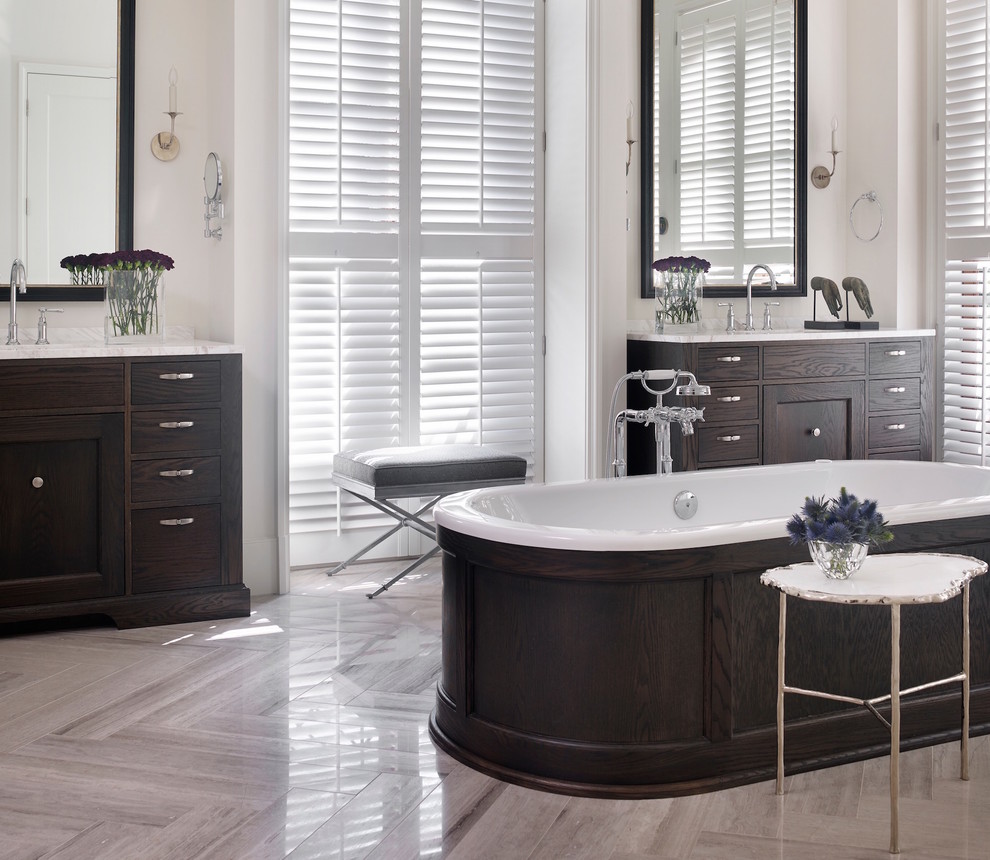 Example of a mid-sized transitional master gray tile and stone tile marble floor freestanding bathtub design in Atlanta with flat-panel cabinets, dark wood cabinets, white walls, an undermount sink and marble countertops