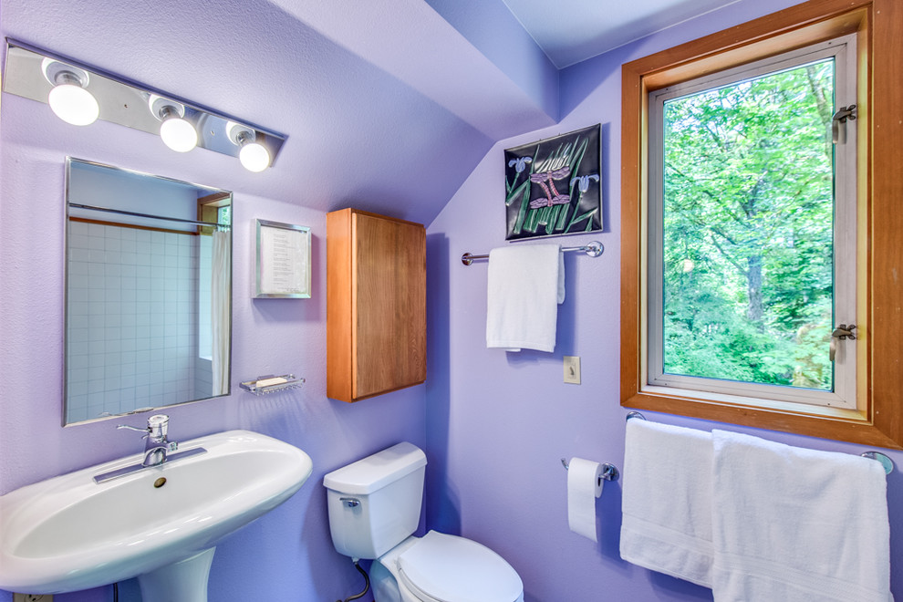 Inspiration for a mid-sized contemporary master white tile and ceramic tile doorless shower remodel in Seattle with flat-panel cabinets, medium tone wood cabinets, purple walls and a pedestal sink