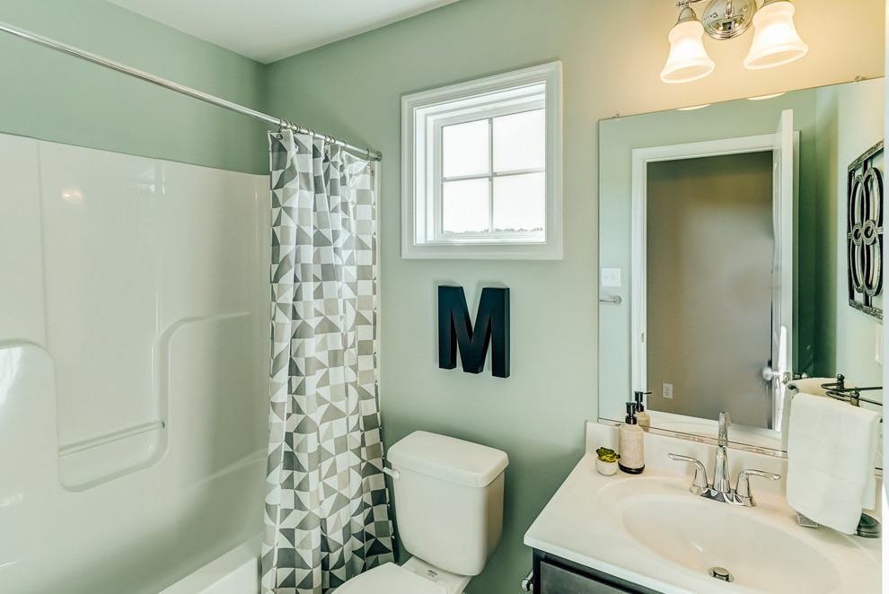 Example of a small classic 3/4 bathroom design in Richmond with shaker cabinets, a two-piece toilet, green walls, an integrated sink and solid surface countertops