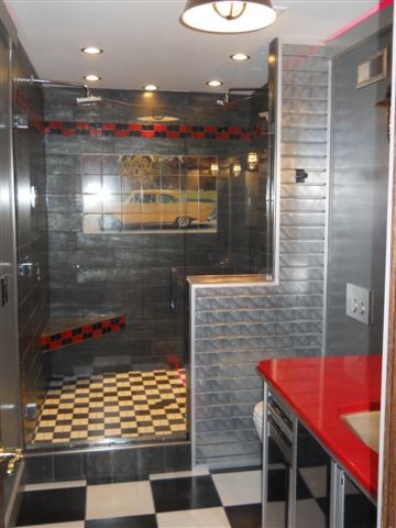 This is an example of a medium sized eclectic shower room bathroom in Cleveland with black cabinets, a double shower, a wall mounted toilet, black and white tiles, ceramic tiles, ceramic flooring, a submerged sink and quartz worktops.