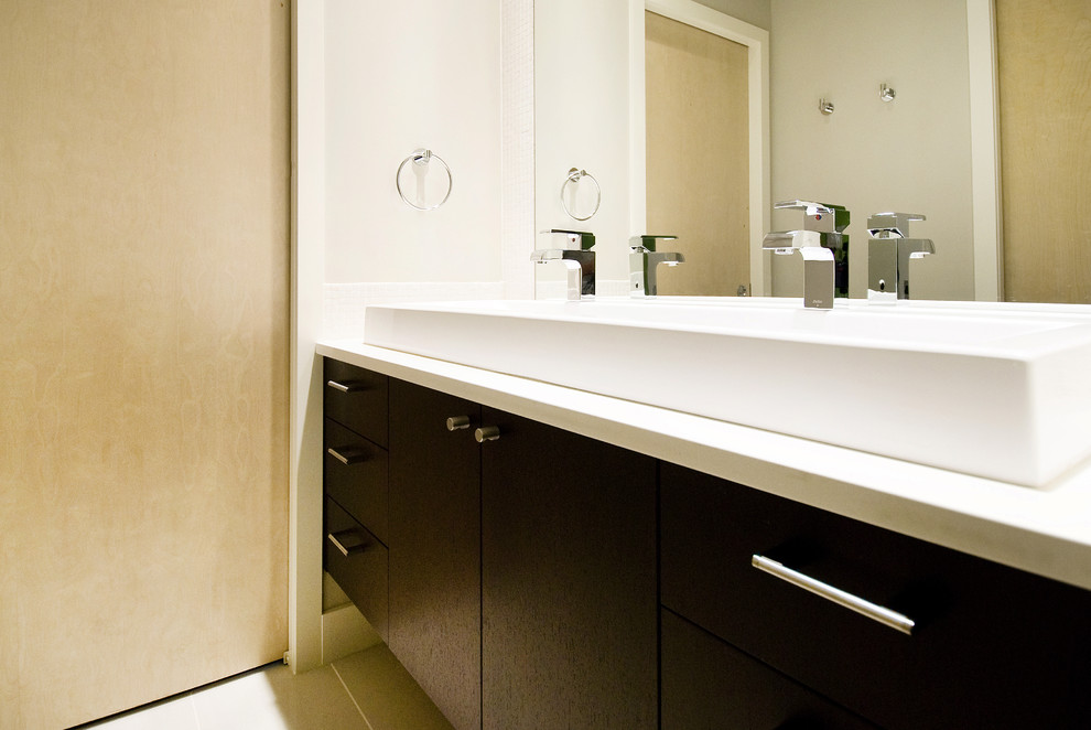 Trendy bathroom photo in Calgary with flat-panel cabinets, dark wood cabinets and quartz countertops