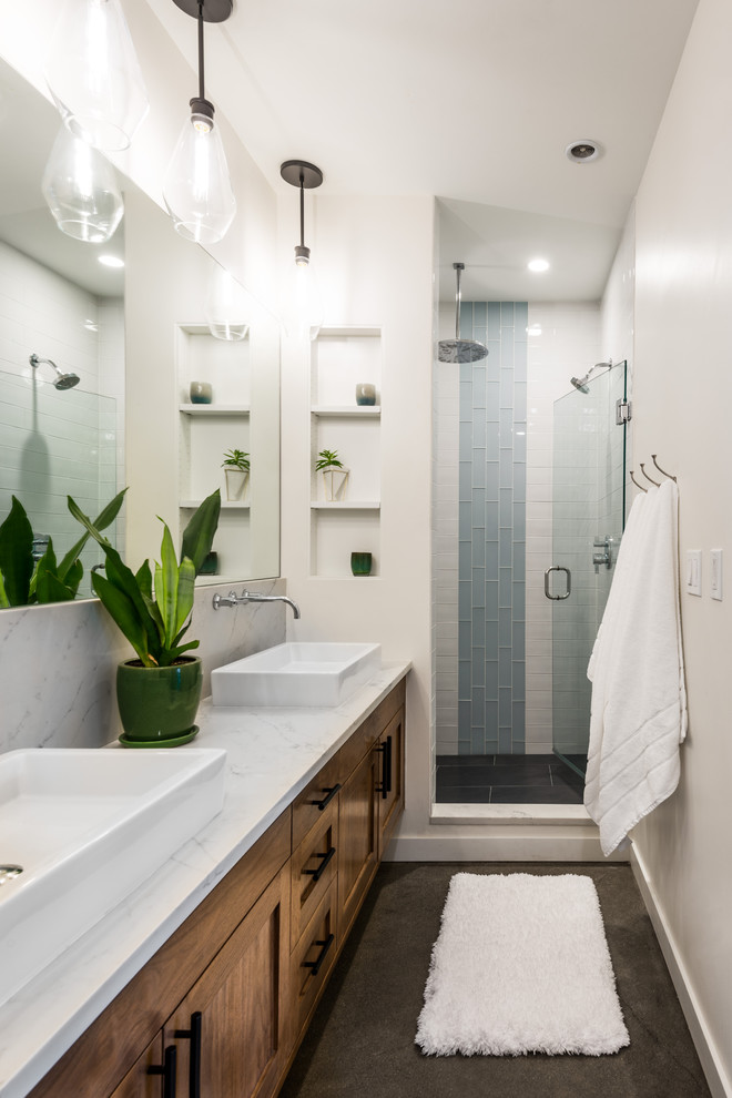 Alcove shower - mid-sized contemporary 3/4 white tile and ceramic tile concrete floor and gray floor alcove shower idea in Seattle with shaker cabinets, white walls, a vessel sink, quartz countertops, a hinged shower door, white countertops and dark wood cabinets