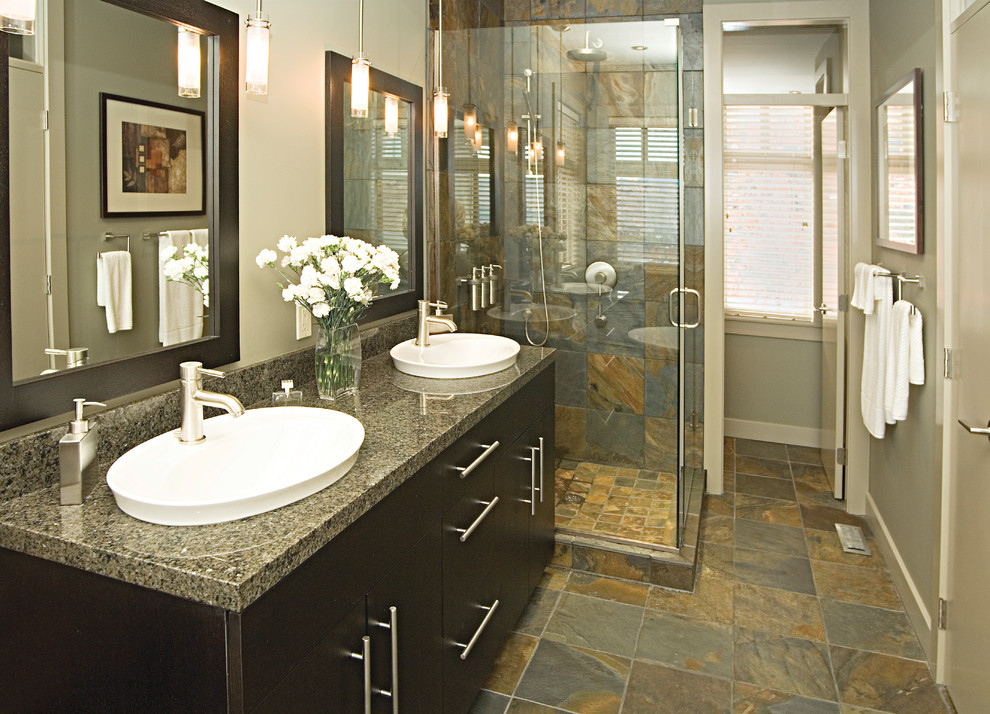 Exemple d'une grande salle de bain principale tendance avec un lavabo posé, des portes de placard noires, une douche d'angle, un carrelage gris, un mur gris et un sol en ardoise.