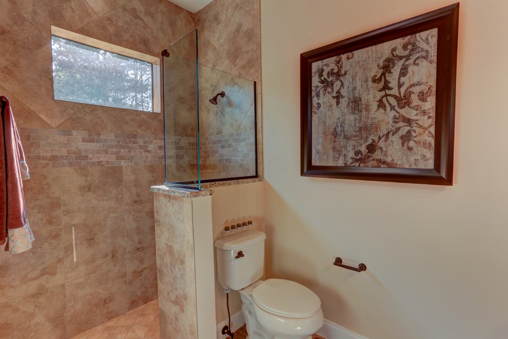 Bathroom - mid-sized transitional master beige tile and ceramic tile ceramic tile bathroom idea in Orlando with recessed-panel cabinets, medium tone wood cabinets, a two-piece toilet, beige walls, an undermount sink and granite countertops