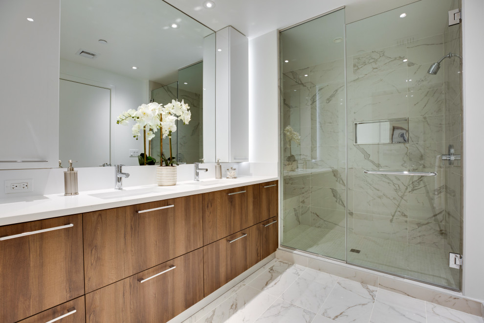 Example of a mid-sized minimalist 3/4 gray tile and marble tile porcelain tile, white floor and double-sink alcove shower design in DC Metro with flat-panel cabinets, dark wood cabinets, white walls, an undermount sink, quartz countertops, a hinged shower door, white countertops and a built-in vanity
