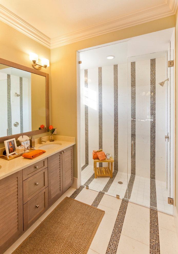 Bathroom - large contemporary multicolored tile and mosaic tile mosaic tile floor and beige floor bathroom idea in Tampa with furniture-like cabinets, brown cabinets, a two-piece toilet, yellow walls, an undermount sink, solid surface countertops and a hinged shower door