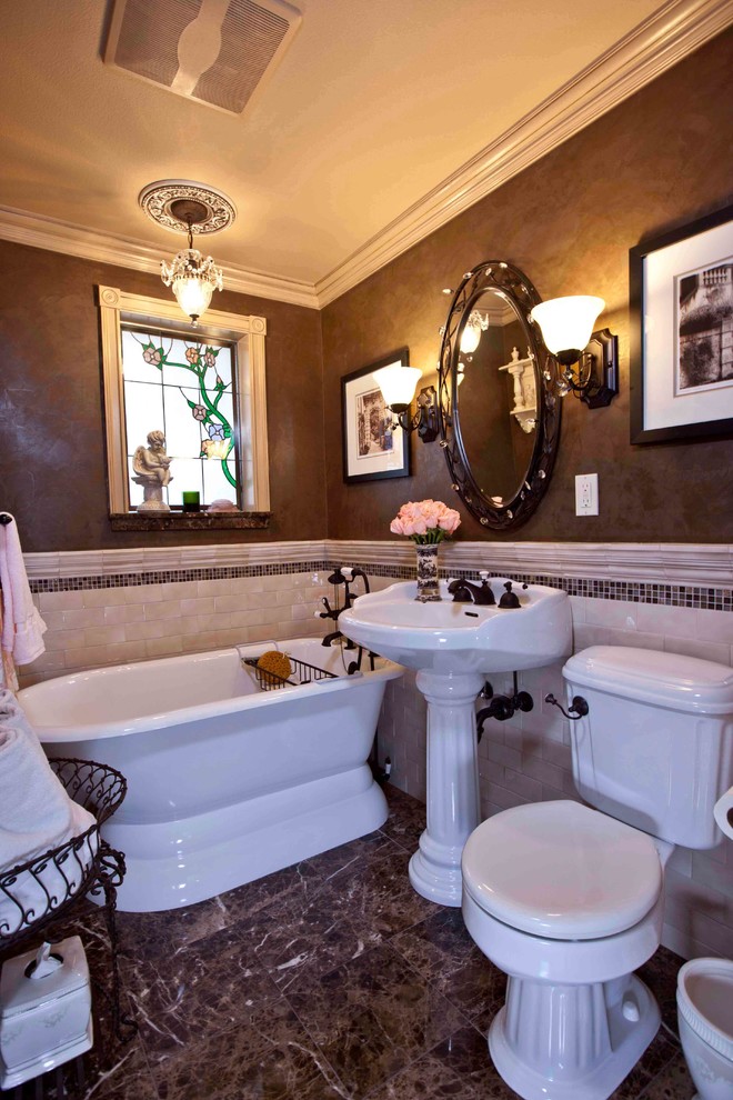 Photo of a small victorian ensuite bathroom in Seattle with a claw-foot bath, a two-piece toilet, beige tiles, ceramic tiles, brown walls, mosaic tile flooring, a pedestal sink and brown floors.