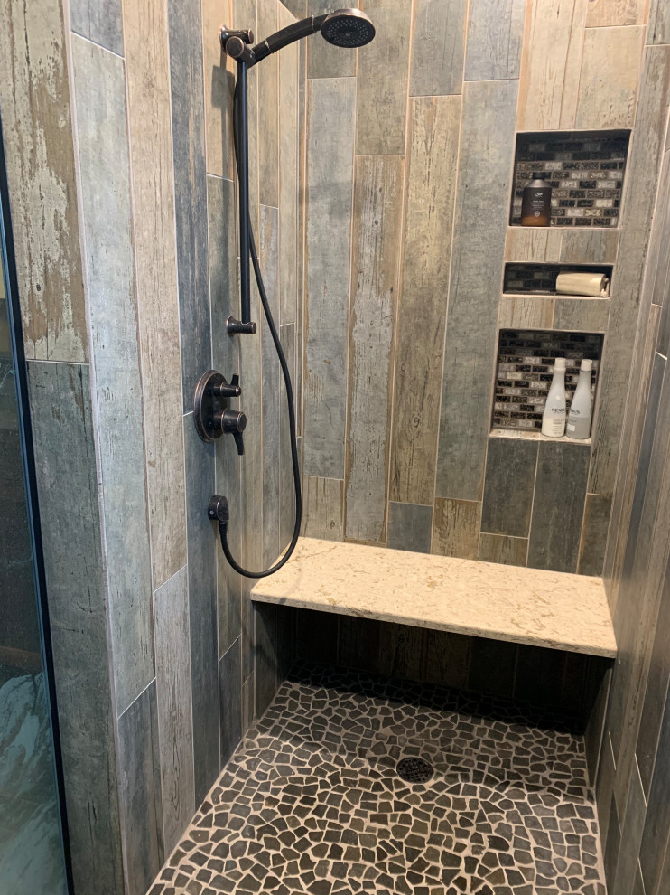 Inspiration for a medium sized rustic ensuite bathroom in Seattle with shaker cabinets, medium wood cabinets, a built-in shower, yellow tiles, glass tiles, yellow walls, porcelain flooring, engineered stone worktops, grey floors, an open shower, beige worktops, a shower bench, double sinks and a built in vanity unit.