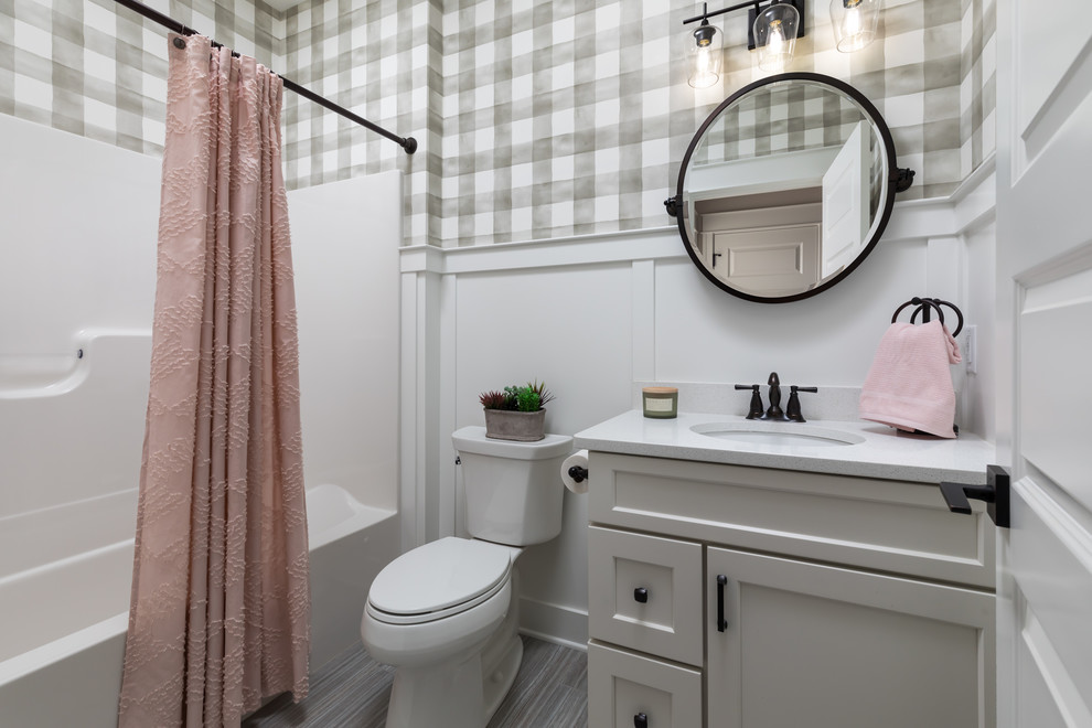 Large beach style 3/4 gray floor and vinyl floor bathroom photo in Grand Rapids with recessed-panel cabinets, white cabinets, a one-piece toilet, multicolored walls, an undermount sink, quartzite countertops and white countertops